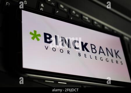 Viersen, Germany - March 1. 2021: Closeup of smartphone screen with logo lettering of binckbank online broker on computer keyboard Stock Photo