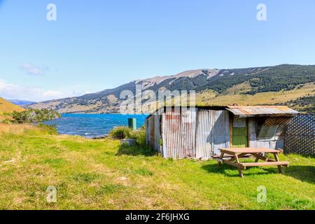 Small boarded up corrugated iron refuge hut on the shore of Laguna Azul in the Torres del Paine National Park, Patagonia, southern Chile Stock Photo