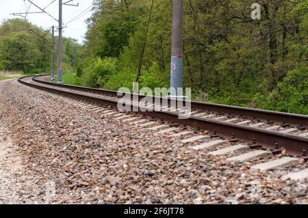 A bend in the railway tracks. No train on the railway track. Railroad tracks turn. Stock Photo