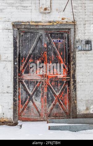 Old and weathered door to a feed store in Stanwood, central Michigan, USA [No property release; available for editorial licensing only] Stock Photo