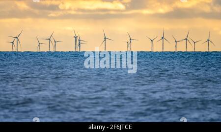 Wind turbines at offshore Rampion Wind Farm at sea in the English Channel in England, UK. Taken from West Sussex coast. Green energy, carbon neutral. Stock Photo