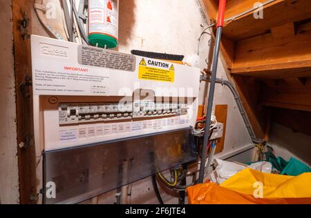 Household electrical circuit breaker box or fuse box for mains electricity safety protection, in a cupboard under stairs in a home in England, UK. Stock Photo