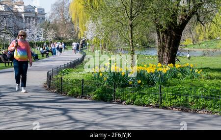 Lady walking on footpath around the lake Regent's Park London UK Stock Photo