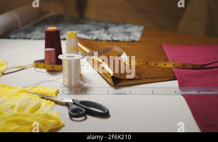 Dressmaker workplace table with sewing set. Professional objects. Craft fashion and style concept Stock Photo