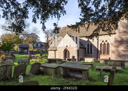 St Mary Magdalene church, set in a circular churchyard, at Hewelsfield in the Forest of Dean, Gloucestershire UK - from under the ancient 8th C yew. Stock Photo