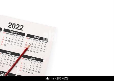 Dates on calendar page 2022 background with pencil. 2022 calendar with pencil on white background business planning appointment meeting concept. copy Stock Photo