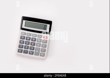 close up white calculator on white background for business financial concept. White digital calculator on the top view isolated on white background Stock Photo