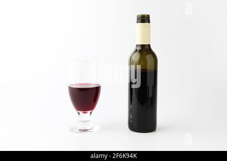 glass and bottle of red wine isolated on white background Stock Photo