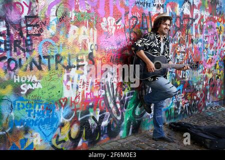 Prague, Czech Republic, 17 September 2018. Street musician plays guitar by John Lennon Wall in Prague, a popular tourist location. Stock Photo