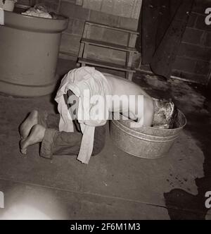 Miner takes washtub bath as most the families do. Westover, West Virginia. 1938. Stock Photo