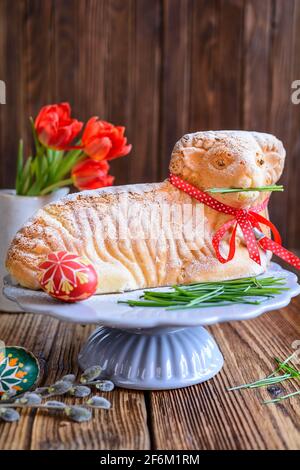 Classic Easter lamb pound cake sprinkled with powdered sugar on wooden background Stock Photo