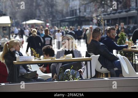 Sofia, Bulgaria - Apr 1 2021: Two women chatting in a cafe outside on the day the cafes were reopened Stock Photo