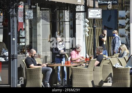 Sofia, Bulgaria - Apr 1 2021: A waitress in protective masks taking the order from a person Stock Photo
