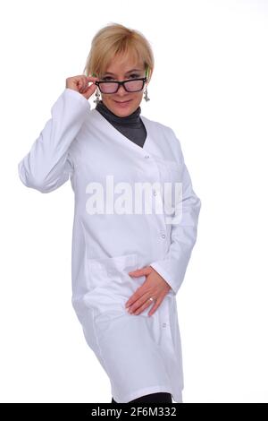 Fifty year old lady doctor in stands wearing a doctor's apron. Front view. Stock Photo