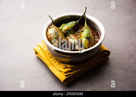 Brinjal curry also known as spicy baingan or eggplant masala, a popular main course recipe from India served in a bowl, karahi or pan Stock Photo
