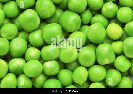 Fresh green peas background texture. Stock Photo