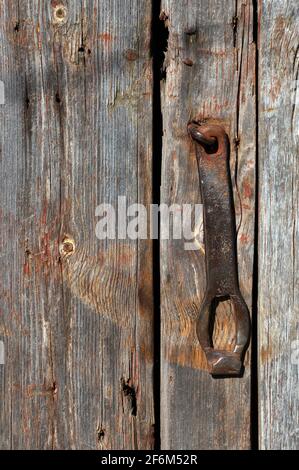 Rusted broken lock on the old wooden door Stock Photo