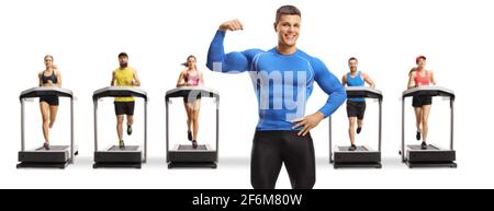 Bodybuilder flexing muscle and people running on treadmills in the back isolated on white background Stock Photo