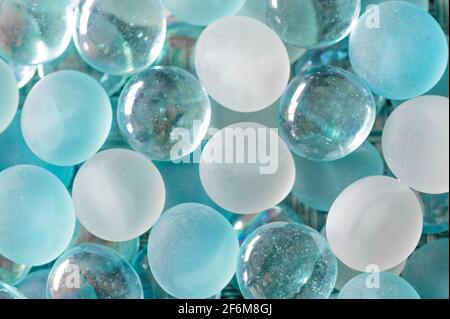 White, Blue, and Clear Glass Marbles Stock Photo