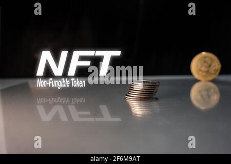 Non-fungible token and NFT words on black background with coin, cyrpto art, NFT Concept Stock Photo