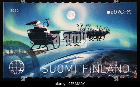 Santa Claus flying on his sleigh in finnish stamp Stock Photo