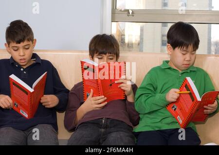 New york City independent elementary school Grade 4 ages 9-10 mathematics group of boys reading The Number Devil