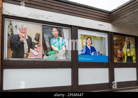 Recruitment posters for occupations in healthcare displayed on the exterior of an NHS building at Royal Hampshire County Hospital, Winchester, UK Stock Photo