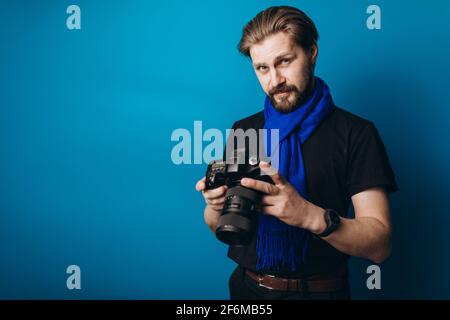 Bearded photographer using camera Stock Photo