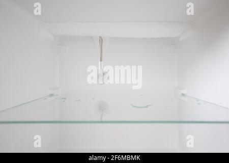 An empty refrigerator. Inside an empty, clean refrigerator, a refrigerator compartment after defrosting. Stock Photo