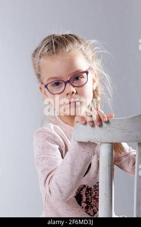 Young stylish girl, model posing with glasses on white background, and  winking eyes Stock Photo - Alamy