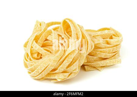 Uncooked tagliatelle pasta isolated on white Stock Photo