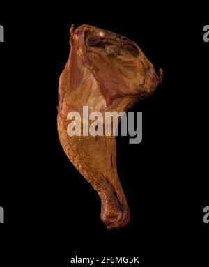 Appetizing smoked chicken legs, Ice, on a black background in isolation poultry meat, chicken smoked meat Stock Photo