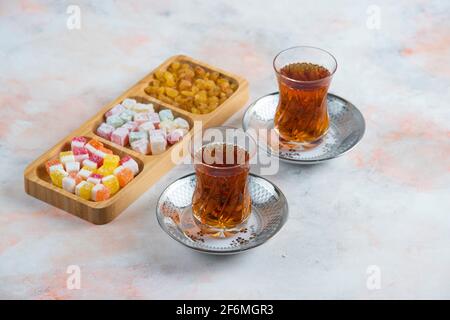 Two glass tea and turkish delights on background Stock Photo