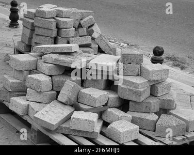 Gray solid concrete construction building bricks on a wooden pallet-Paving bricks Stock Photo