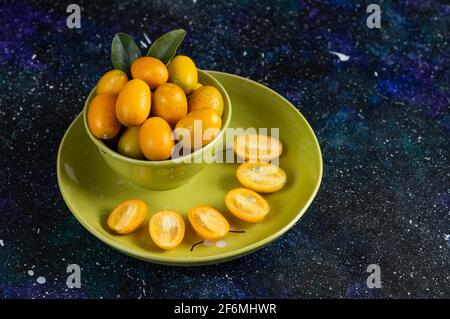 Fresh organic kumquats whole or half cut Stock Photo