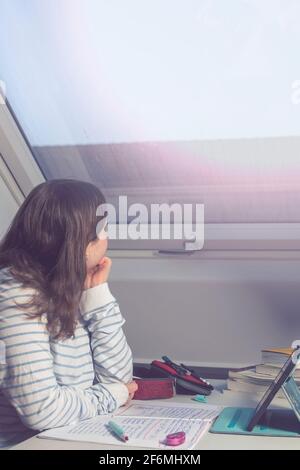 Schoolgirl looking through homework Stock Photo - Alamy