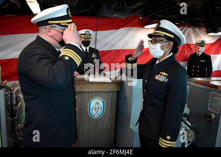 U.S. Navy Cmdr. Matthew R. Shellock, left, salutes incoming commanding officer Cmdr. LaDonna M. Simpson, of the Harpers Ferry-class amphibious dock landing ship USS Carter Hall during a change of command ceremony January 21, 2021 in Virginia Beach, Virginia. Stock Photo