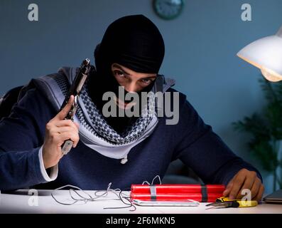 The terrorist bomber preparing dynamite bomb Stock Photo