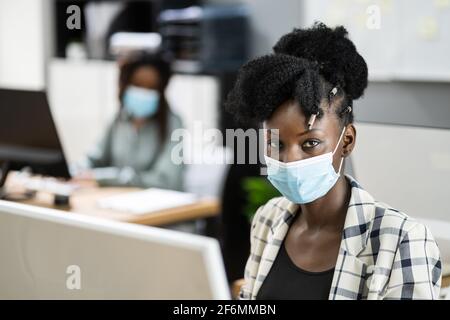 Business People In Medical Covid Face Masks Stock Photo