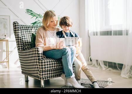 Mother with son in children's room, looking at tablet  Stock Photo