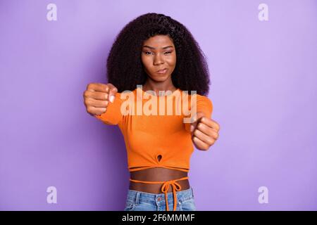 Photo of cute confident dark skin woman dressed orange shirt driving car isolated purple color background Stock Photo