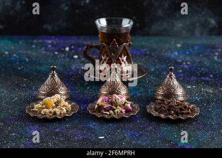 Fragrant tea behind of various herbs on grey background Stock Photo