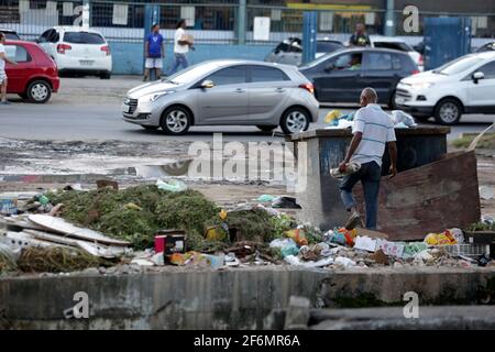 salvador, bahia / brazil - june 1, 2017: person is seen beside the trash collecting material for recycling in the city of Salvador.    *** Local Capti Stock Photo