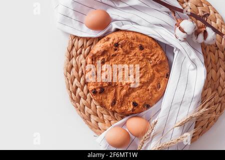 Easter cake and eggs on wicker cloth. Top view copy space. Isolated on white. Cookies pie or cake recipe Stock Photo