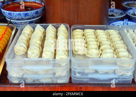 Different types of dumplings ready to be steamed in a street side restaurant. A popular and traditional Chinese snack food. Stock Photo