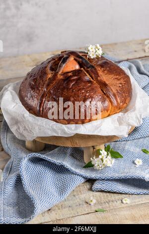 Portuguese traditional Easter cake. Folar with eggs on easter table. Colorful painted eggs. Stock Photo