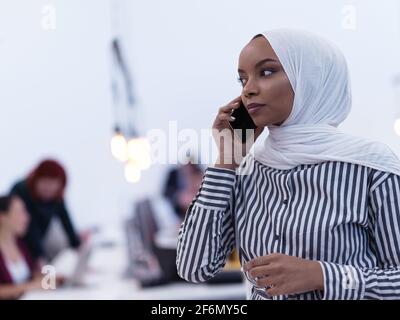African Muslim Businesswoman Using Smart Phone Wearing Hijab At Creative Modern Startup Coworking Open Space Office Stock Photo Alamy