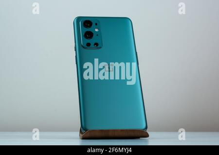 OnePlus 9 Pro 5G in Pine Green color. Stock Photo