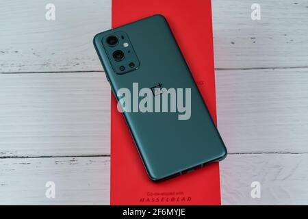 OnePlus 9 Pro 5G in Pine Green color. Stock Photo