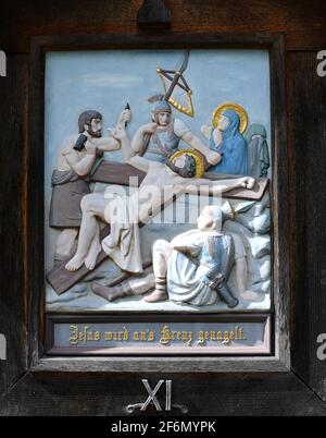 Eschenlohe, Germany. 01st Apr, 2021. The eleventh station on a Way of the Cross up to St. Nicholas on the Vestbichl shows 'Jesus is nailed to the cross'. Credit: Angelika Warmuth/dpa/Alamy Live News Stock Photo